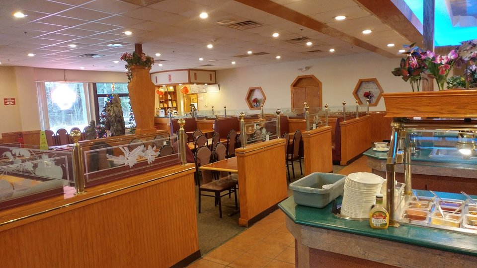Buffet trays lined up in a Chinese restaurant.