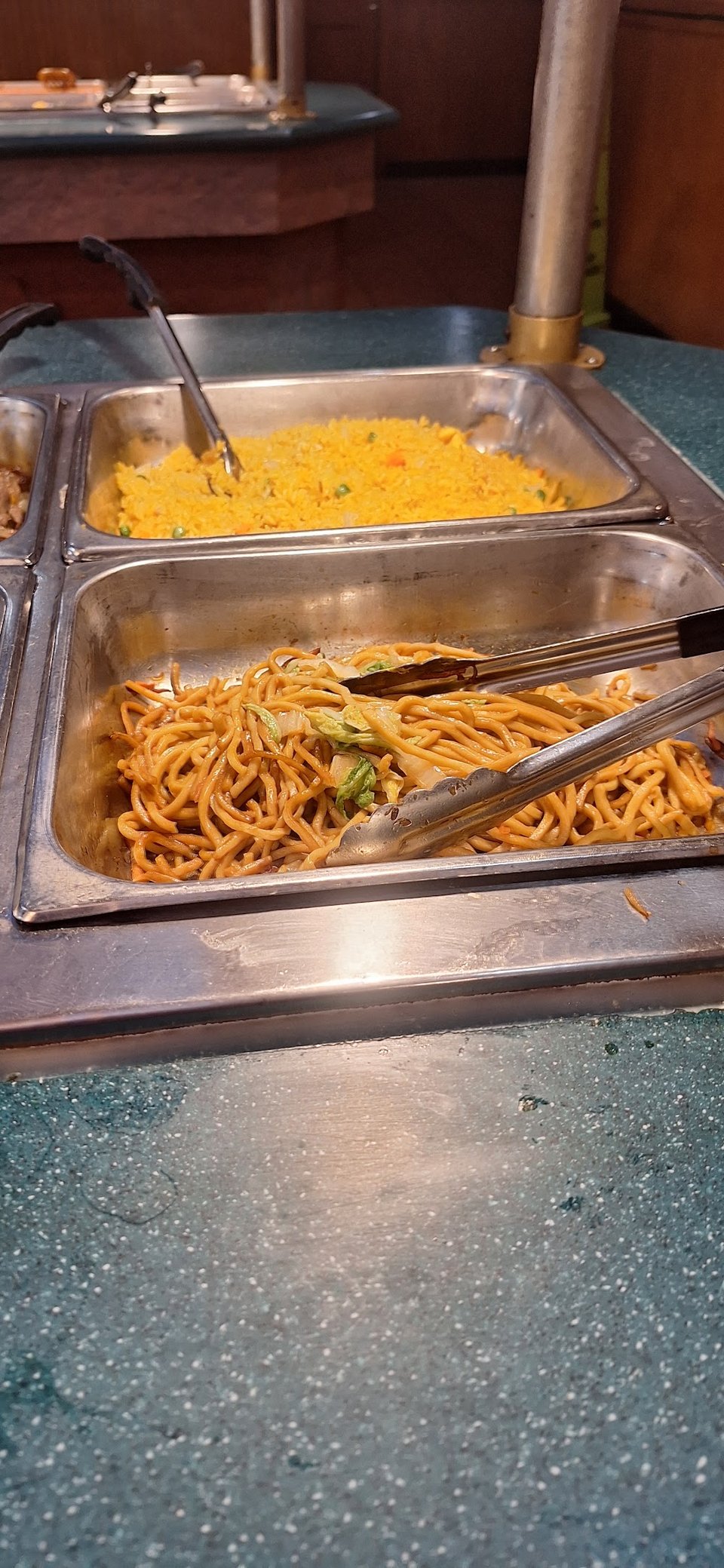 Chinese buffet dishes served in metal trays.